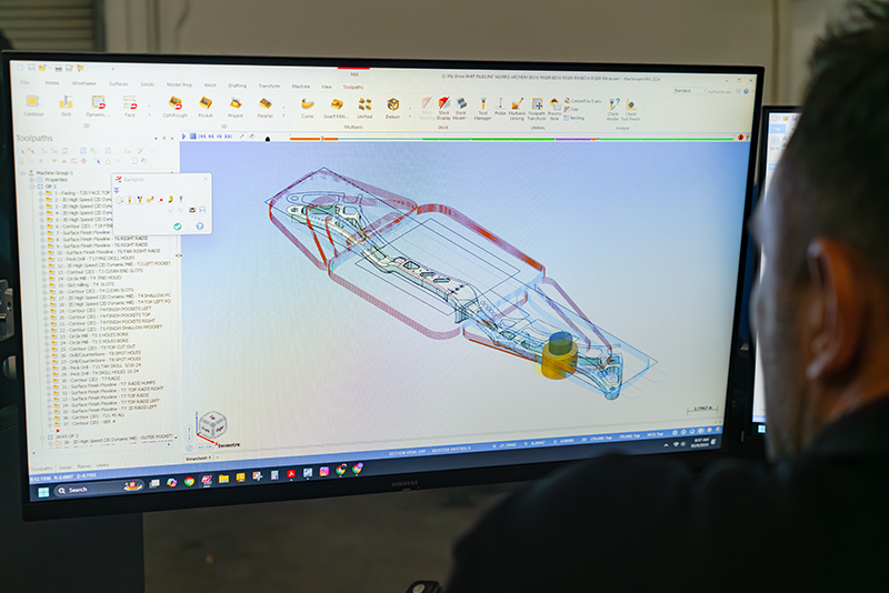 technician working on multi-axis drawing.